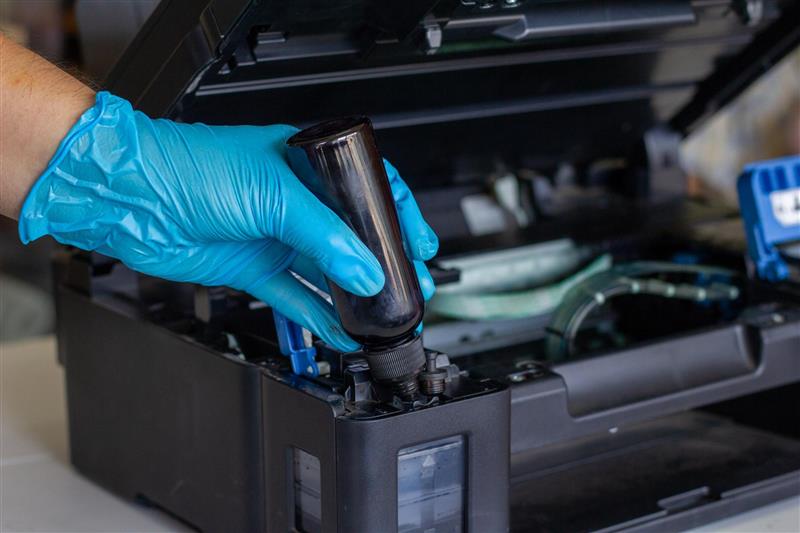 Repairman servicing a printer onsite